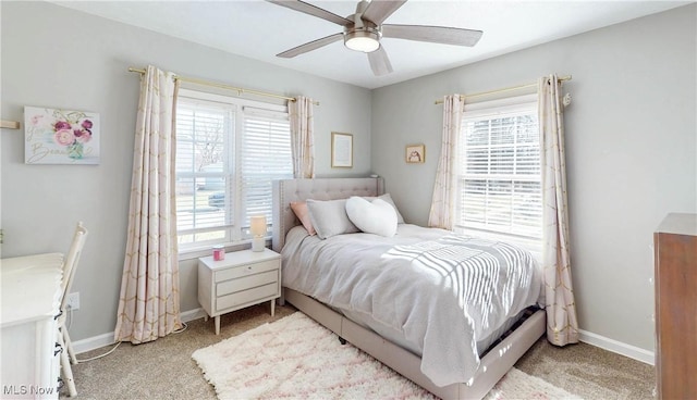 bedroom with light colored carpet, baseboards, and ceiling fan