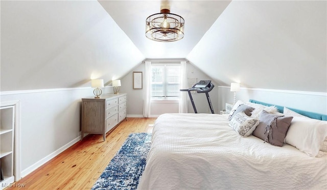 bedroom featuring lofted ceiling, light wood-style flooring, and baseboards