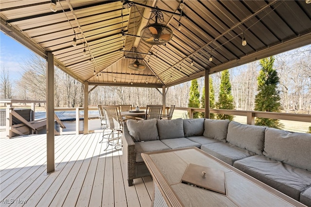 wooden terrace featuring outdoor dining space and an outdoor hangout area