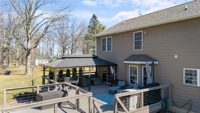 deck featuring a gazebo, a lawn, and an outdoor hangout area