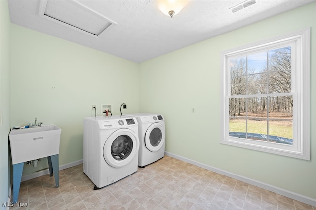 laundry room with laundry area, plenty of natural light, visible vents, and washer and clothes dryer