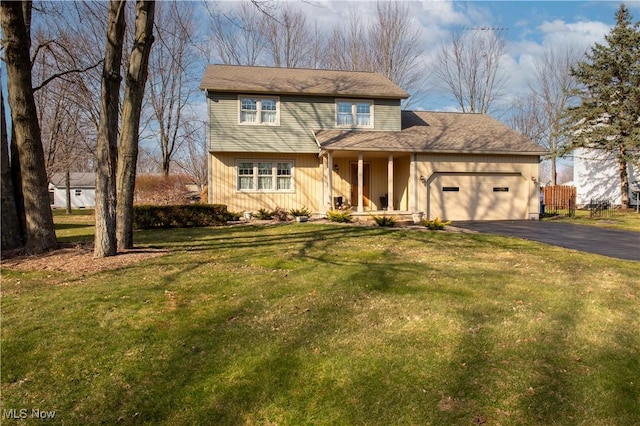 view of front of house featuring a front yard, an attached garage, and driveway