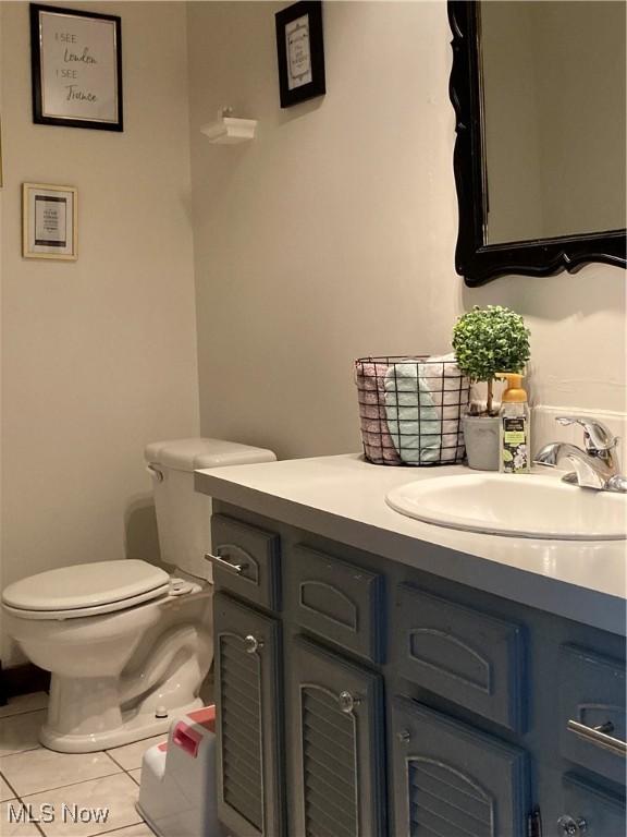 bathroom with tile patterned floors, toilet, and vanity