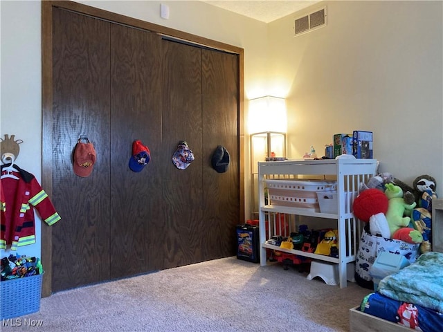 bedroom featuring visible vents, carpet, and a closet