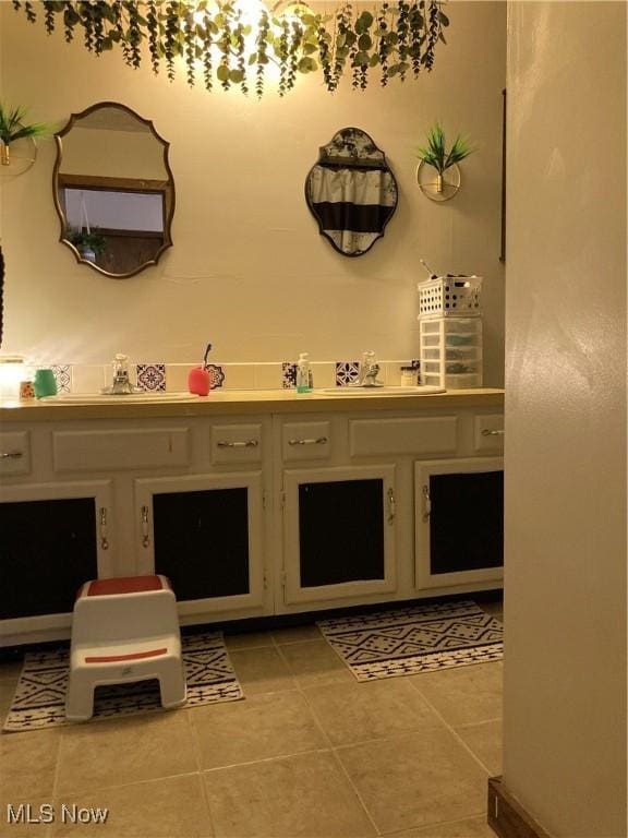 bathroom with a sink and tile patterned floors