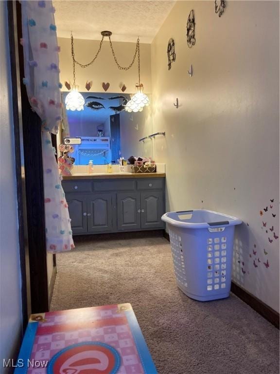 bathroom featuring vanity, baseboards, and a textured ceiling