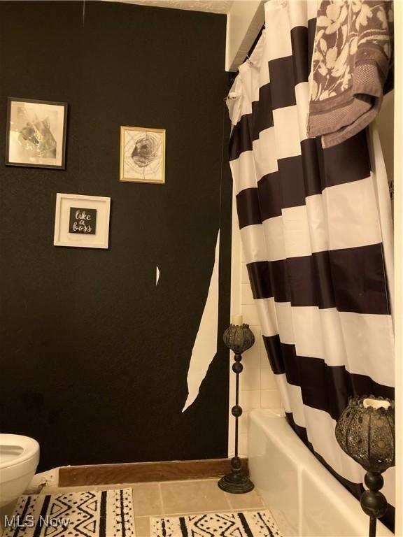 bathroom with tile patterned flooring and toilet