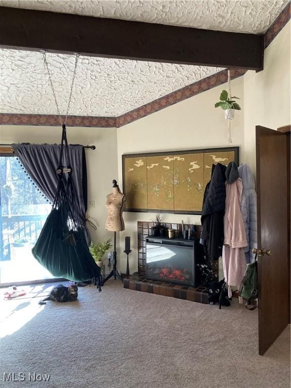 living area featuring lofted ceiling with beams, carpet floors, and a fireplace