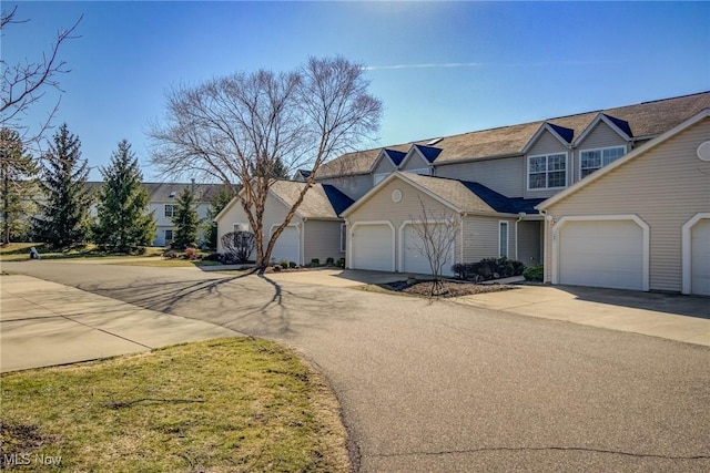 traditional-style home with a residential view, a garage, and driveway