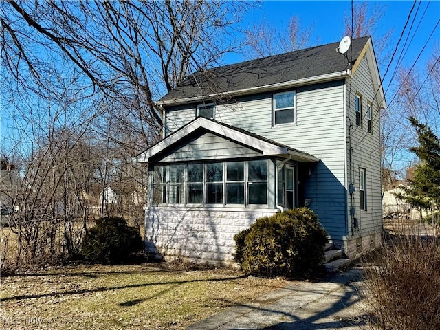 view of front of house featuring a sunroom