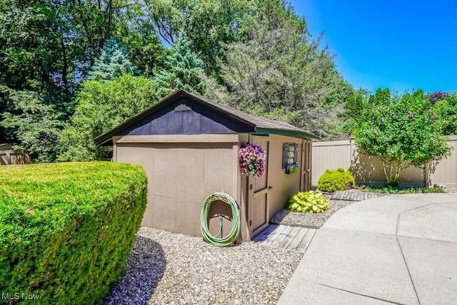 view of shed featuring fence