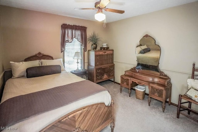 carpeted bedroom with a ceiling fan and baseboards