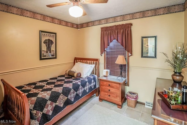 bedroom featuring tile patterned flooring, baseboards, and a textured ceiling