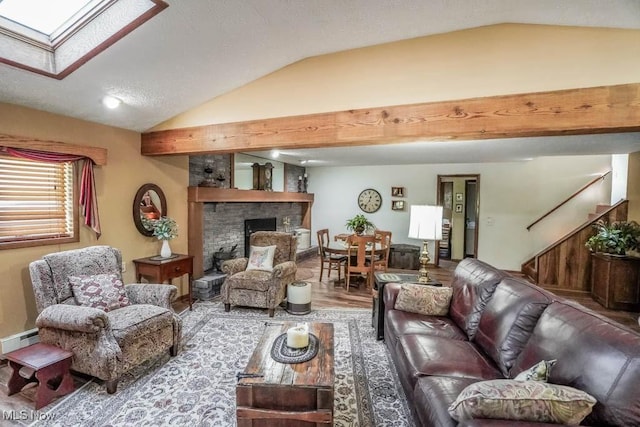 living room with vaulted ceiling with skylight, baseboard heating, a brick fireplace, and wood finished floors