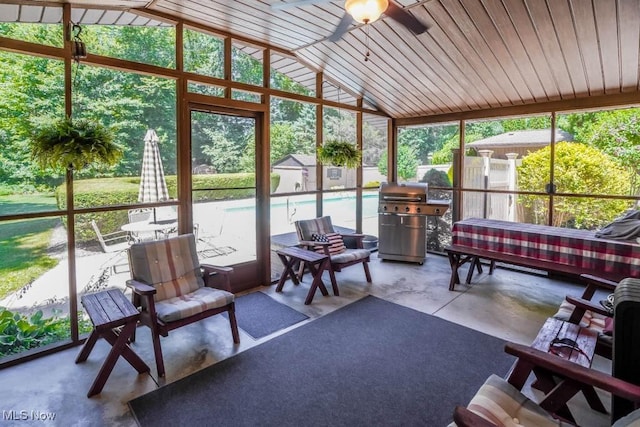 sunroom with vaulted ceiling and a ceiling fan