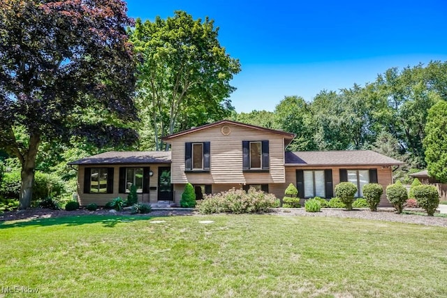 split level home with a front lawn