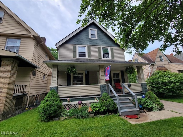 view of front of house with a porch and a front yard