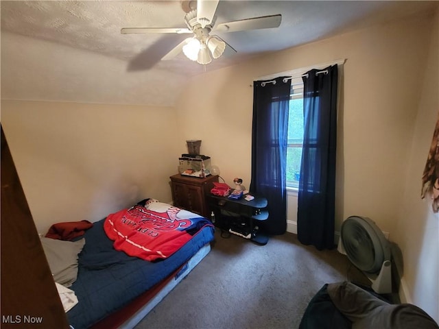 carpeted bedroom featuring ceiling fan and vaulted ceiling