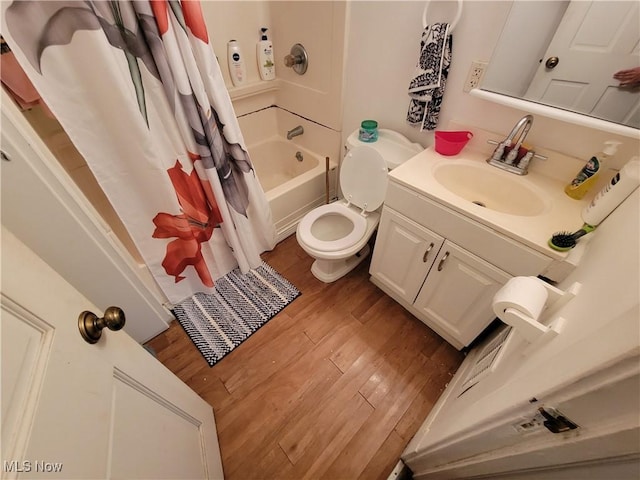 bathroom with toilet, shower / bathtub combination with curtain, vanity, and wood finished floors