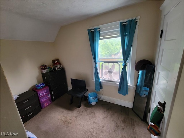 carpeted bedroom featuring baseboards and vaulted ceiling