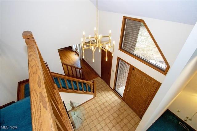 entrance foyer featuring stairway and a notable chandelier