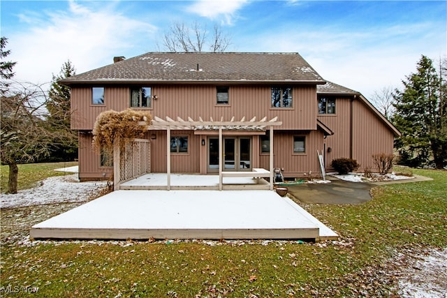 rear view of property with a yard, a pergola, a patio, and roof with shingles