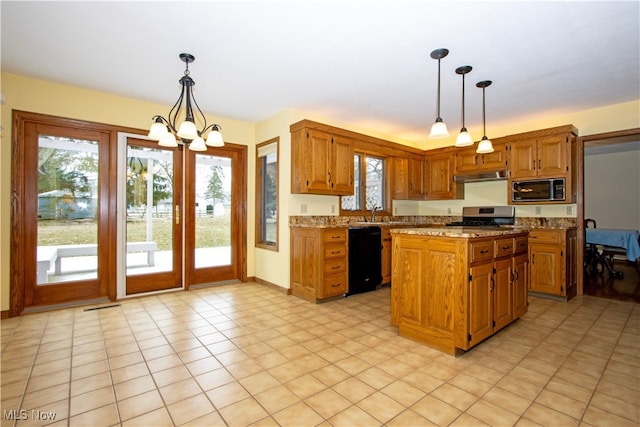 kitchen with a healthy amount of sunlight, built in microwave, under cabinet range hood, black dishwasher, and gas stove