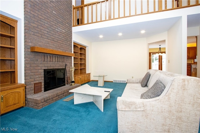 carpeted living room with built in shelves, visible vents, baseboards, a high ceiling, and a fireplace