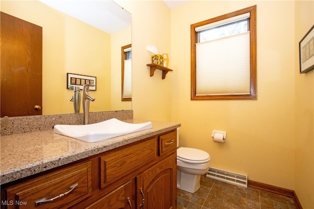 bathroom with visible vents, baseboards, toilet, and vanity