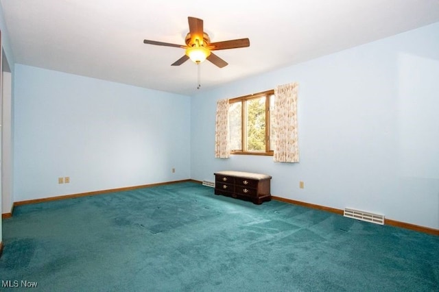 carpeted empty room with a ceiling fan, baseboards, and visible vents