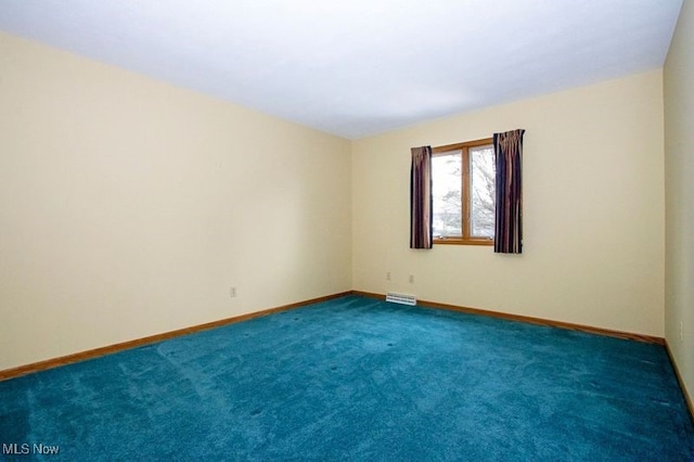 unfurnished room featuring baseboards and carpet floors