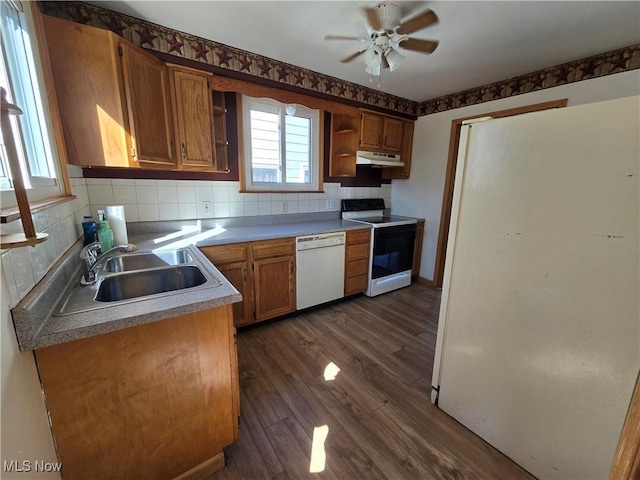 kitchen with under cabinet range hood, open shelves, white appliances, decorative backsplash, and dark wood-style flooring