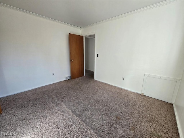 unfurnished room featuring crown molding, visible vents, and carpet floors