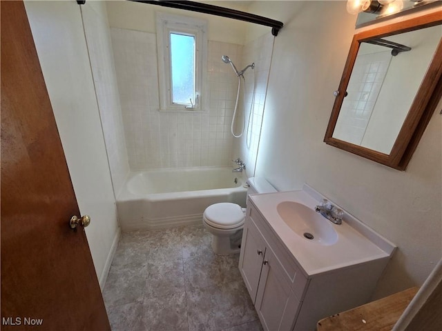 bathroom featuring baseboards, toilet, vanity, and shower / bathing tub combination