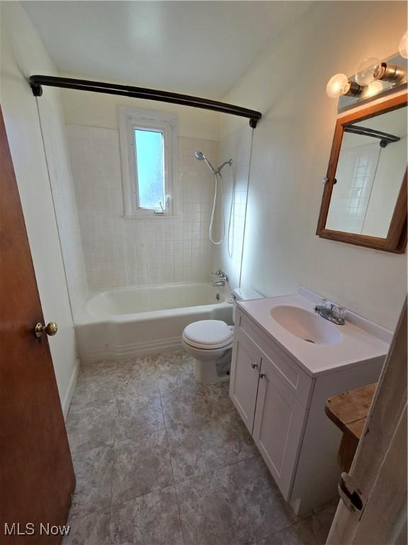 full bathroom with bathing tub / shower combination, vanity, and toilet