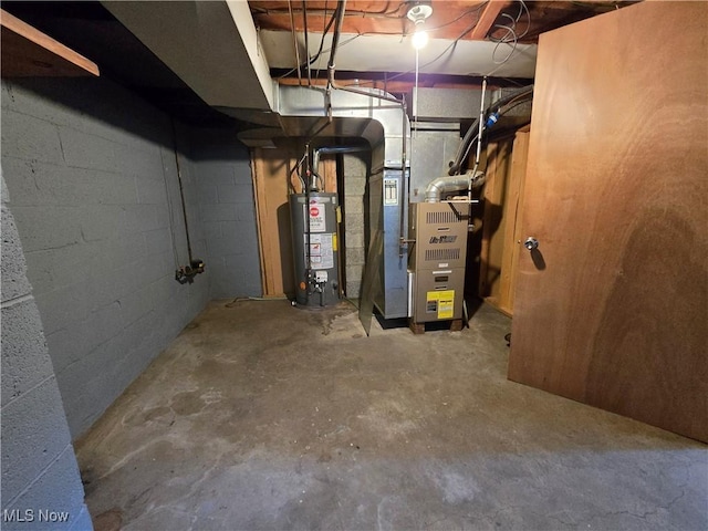 unfinished basement featuring gas water heater and heating unit