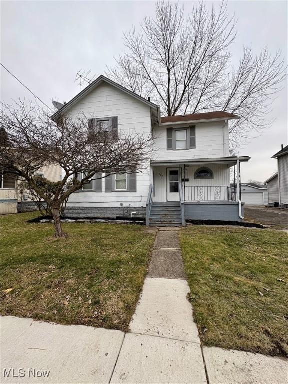 view of front of property with covered porch and a front yard