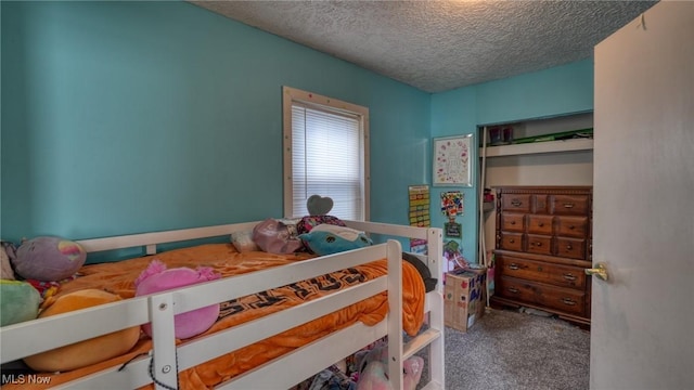 bedroom featuring a textured ceiling and carpet floors