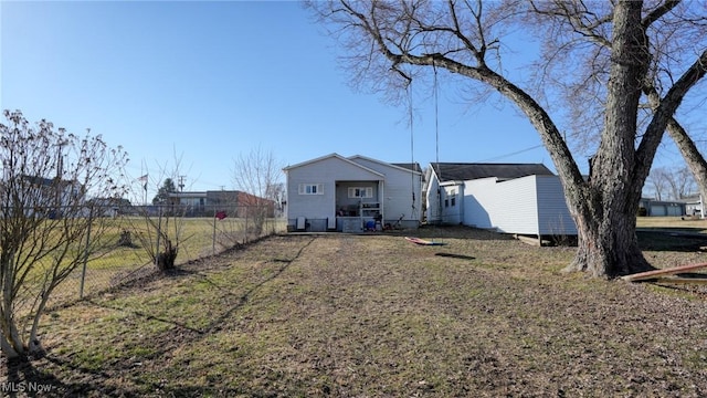 rear view of property featuring fence