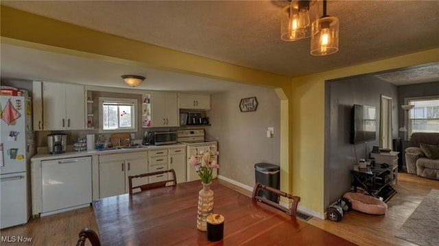 dining area with baseboards and wood finished floors