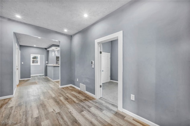 interior space featuring visible vents, baseboards, and wood finished floors