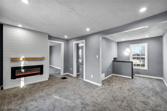 unfurnished living room featuring baseboards, visible vents, carpet floors, recessed lighting, and a large fireplace