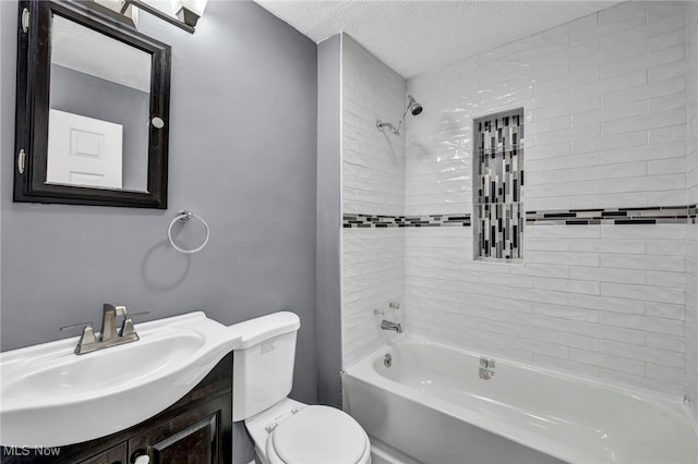 bathroom with vanity, a textured ceiling, bathing tub / shower combination, and toilet