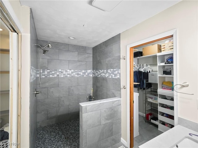 bathroom with a walk in closet and walk in shower