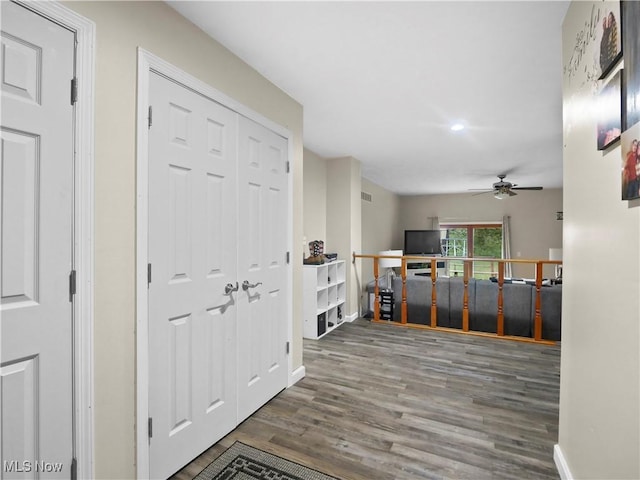 hallway with visible vents, baseboards, and wood finished floors