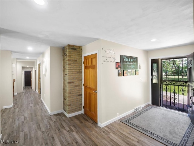 entryway featuring recessed lighting, baseboards, and wood finished floors