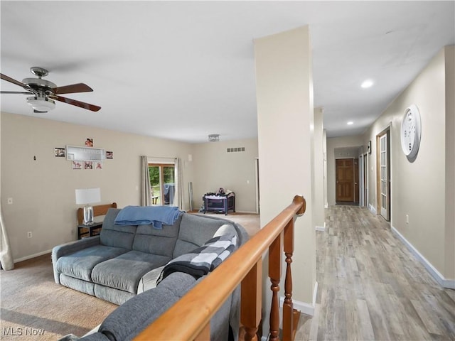 living room featuring recessed lighting, visible vents, baseboards, and light wood finished floors