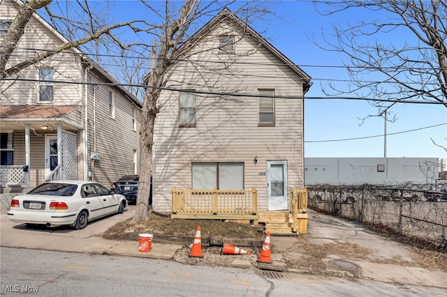 view of front of house featuring fence