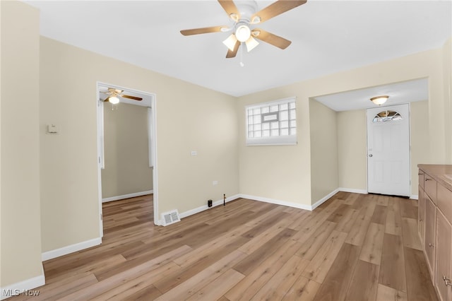 unfurnished room with visible vents, baseboards, light wood-style flooring, and a ceiling fan