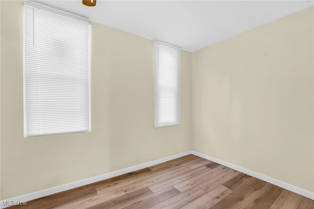 empty room featuring baseboards and wood finished floors